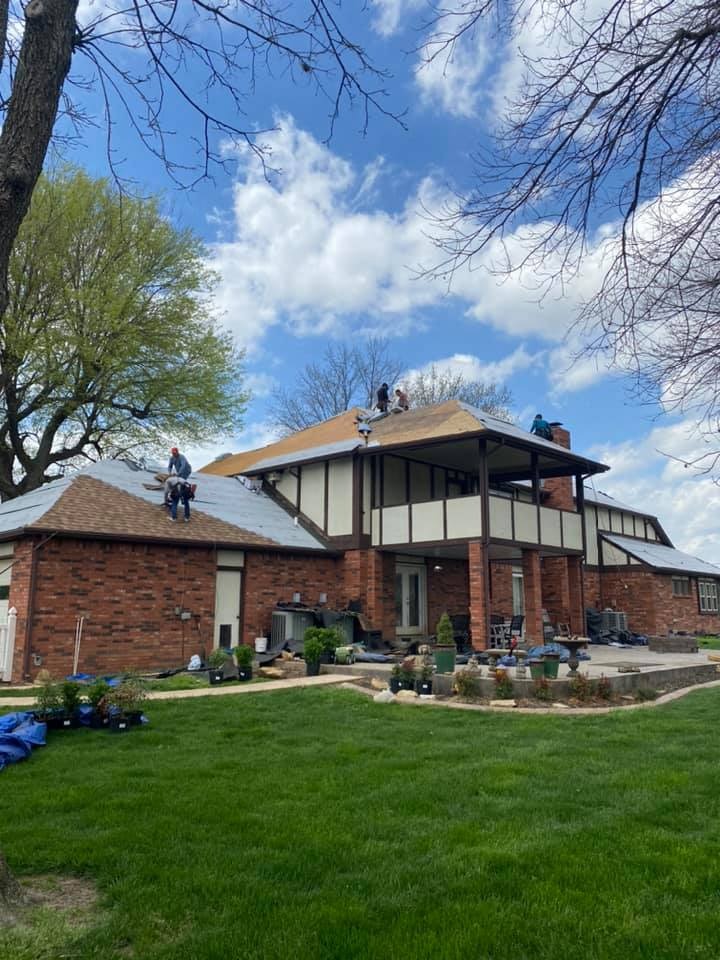 Crew working on a large home with dormers